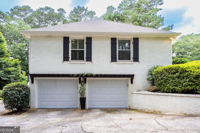 3548 Liberty Ln, Marietta, GA 30062 - view of front of home featuring a garage, brick siding, driveway, and roof with shingles
