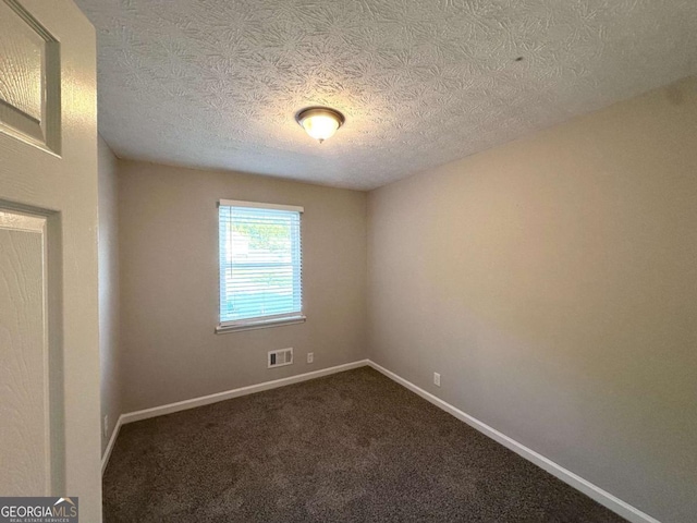2784 Rockdale Dr, Decatur, GA 30034 - spare room with baseboards, a textured ceiling, and dark colored carpet