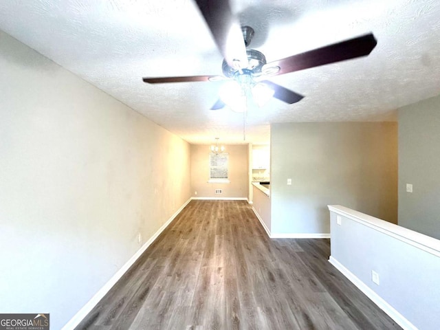 2784 Rockdale Dr, Decatur, GA 30034 - spare room featuring a textured ceiling, a ceiling fan, wood finished floors, baseboards, and a chandelier