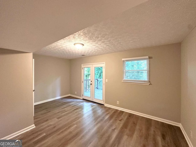 2784 Rockdale Dr, Decatur, GA 30034 - empty room featuring wood finished floors, baseboards, a textured ceiling, and french doors