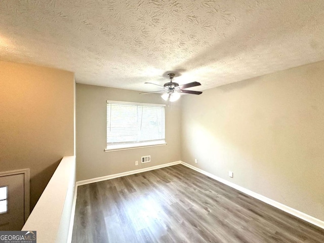 2784 Rockdale Dr, Decatur, GA 30034 - empty room with dark wood-style flooring, ceiling fan, a textured ceiling, and baseboards