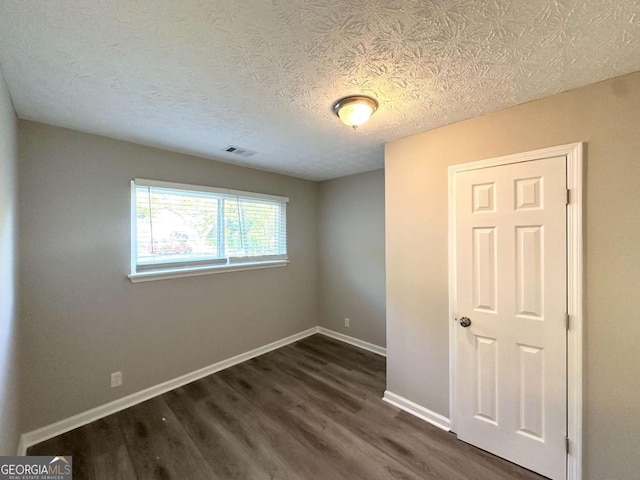 2784 Rockdale Dr, Decatur, GA 30034 - empty room with dark wood-style floors, baseboards, and a textured ceiling