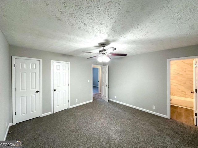 2784 Rockdale Dr, Decatur, GA 30034 - unfurnished bedroom featuring baseboards, carpet, two closets, a textured ceiling, and ensuite bath