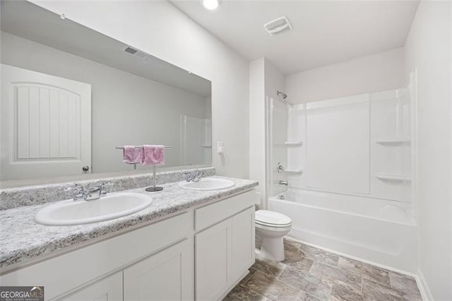 312 Deer Run Dr, Dallas, GA 30132 - bathroom featuring double vanity, toilet, bathtub / shower combination, stone finish flooring, and baseboards