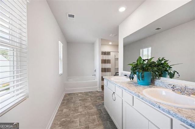 312 Deer Run Dr, Dallas, GA 30132 - full bath with double vanity, a bathtub, stone finish floors, a shower with curtain, and recessed lighting