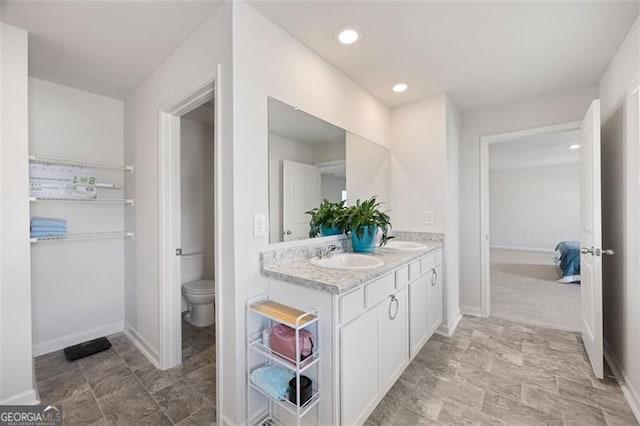 312 Deer Run Dr, Dallas, GA 30132 - bathroom with double vanity, toilet, baseboards, and recessed lighting