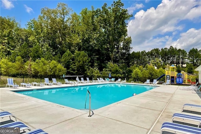 312 Deer Run Dr, Dallas, GA 30132 - community pool featuring a patio and view of scattered trees
