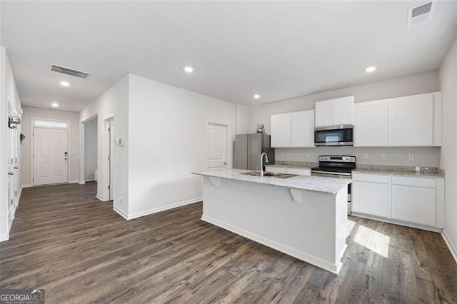 312 Deer Run Dr, Dallas, GA 30132 - kitchen featuring stainless steel appliances, a sink, dark wood-type flooring, white cabinets, and recessed lighting