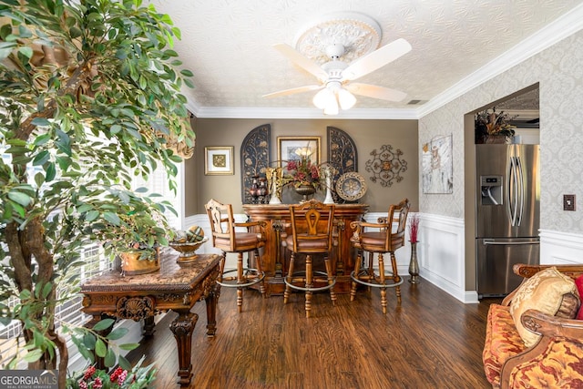 7282 Litany Ct, Flowery Branch, GA 30542 - dining area featuring wainscoting, ceiling fan, dark wood-type flooring, a textured ceiling, and ornamental molding