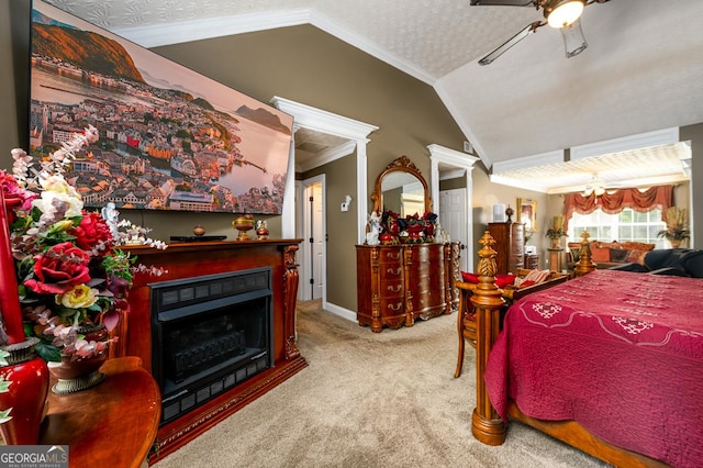 7282 Litany Ct, Flowery Branch, GA 30542 - carpeted bedroom featuring lofted ceiling, a fireplace, ornamental molding, and a ceiling fan