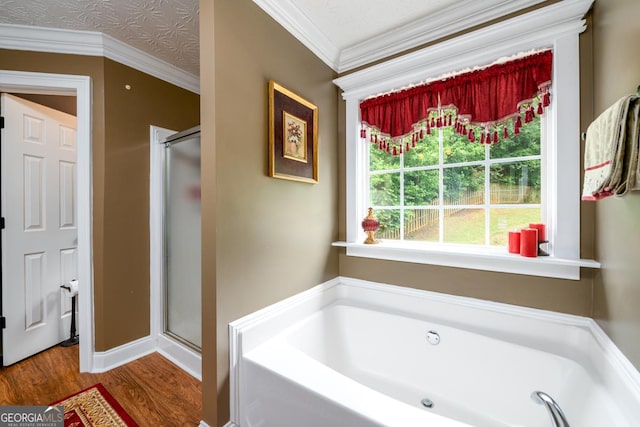 7282 Litany Ct, Flowery Branch, GA 30542 - bathroom featuring wood finished floors, a shower stall, a bath, and crown molding