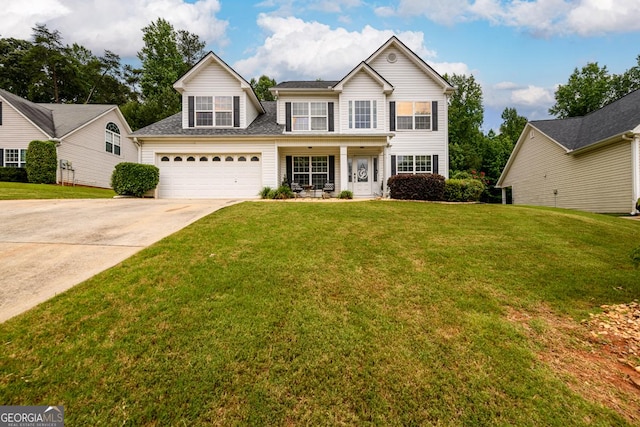 7282 Litany Ct, Flowery Branch, GA 30542 - traditional home with concrete driveway, a front lawn, and covered porch