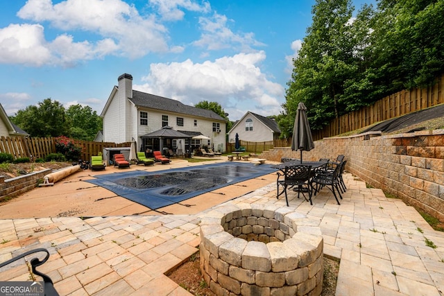 7282 Litany Ct, Flowery Branch, GA 30542 - view of swimming pool featuring a gazebo, a patio area, a fire pit, a fenced backyard, and outdoor dining area