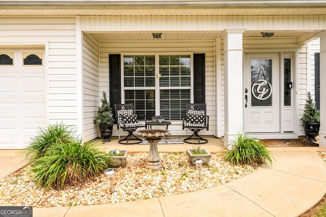 7282 Litany Ct, Flowery Branch, GA 30542 - property entrance featuring covered porch and an attached garage
