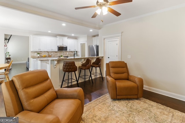 152 Jackson Dr, Forsyth, GA 31029 - living area with baseboards, dark wood finished floors, recessed lighting, crown molding, and ceiling fan