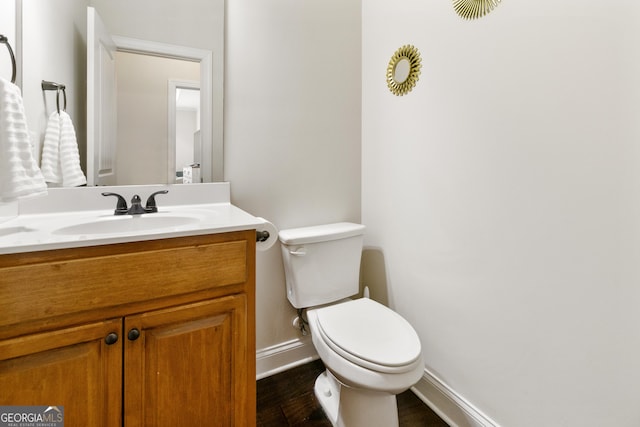 152 Jackson Dr, Forsyth, GA 31029 - half bath featuring baseboards, toilet, vanity, and wood finished floors