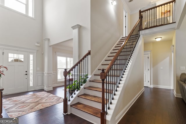 152 Jackson Dr, Forsyth, GA 31029 - foyer entrance featuring a high ceiling, plenty of natural light, ornate columns, wood-type flooring, and crown molding