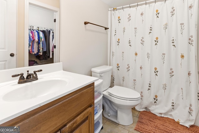 152 Jackson Dr, Forsyth, GA 31029 - bathroom with tile patterned floors, vanity, toilet, a shower with curtain, and a walk in closet