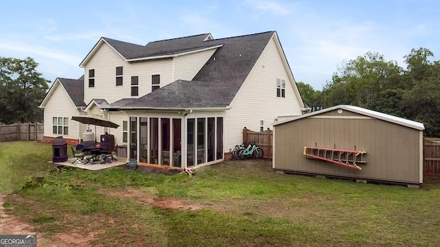 152 Jackson Dr, Forsyth, GA 31029 - rear view of property with a shingled roof, a sunroom, a patio area, and an outdoor structure