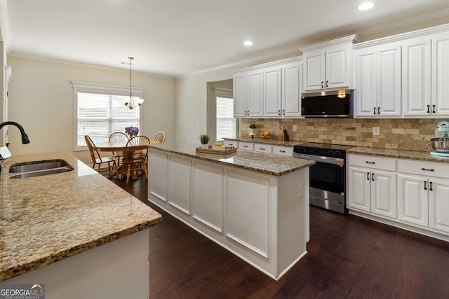 152 Jackson Dr, Forsyth, GA 31029 - kitchen featuring stainless steel appliances, a sink, a center island, dark wood-style floors, and tasteful backsplash