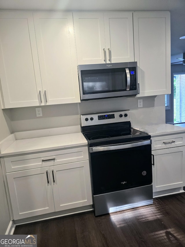 5425 Herndon Blvd, Morrow, GA 30260 - kitchen with appliances with stainless steel finishes, dark wood-style floors, white cabinets, and light countertops