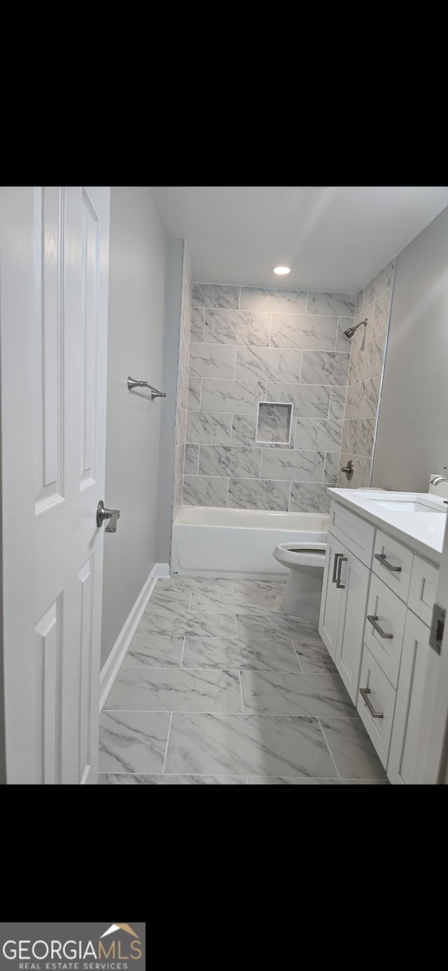 5425 Herndon Blvd, Morrow, GA 30260 - full bathroom featuring vanity, toilet, marble look tile flooring, tub / shower combination, and baseboards