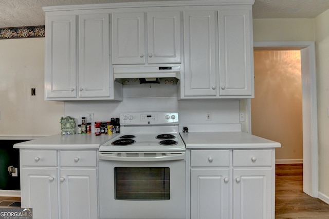 3265 Bold Springs Rd, Dacula, GA 30019 - kitchen featuring white range with electric cooktop, under cabinet range hood, light countertops, and wood finished floors