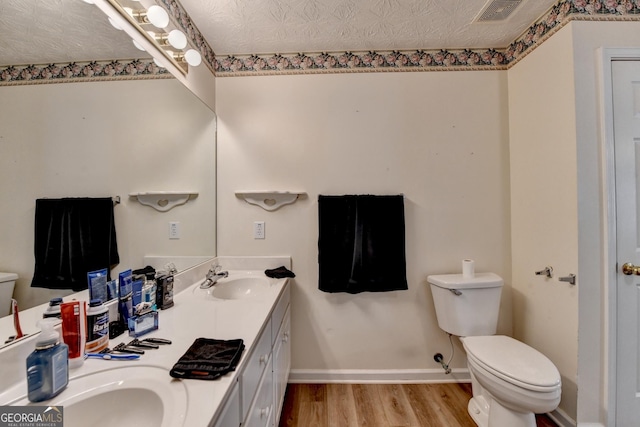 3265 Bold Springs Rd, Dacula, GA 30019 - bathroom with toilet, wood finished floors, double vanity, and baseboards