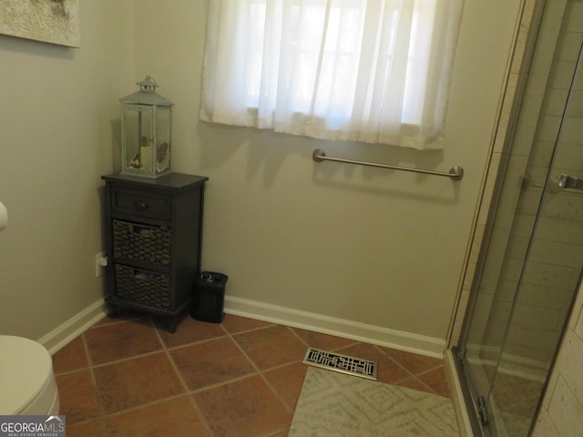 141 Cherokee Cir, Cedartown, GA 30125 - bathroom featuring a stall shower, toilet, baseboards, and tile patterned floors