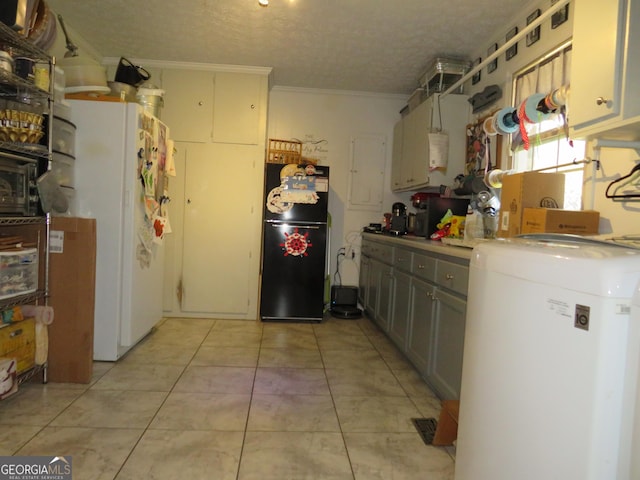 141 Cherokee Cir, Cedartown, GA 30125 - kitchen featuring freestanding refrigerator, washer / clothes dryer, crown molding, a textured ceiling, and light tile patterned floors