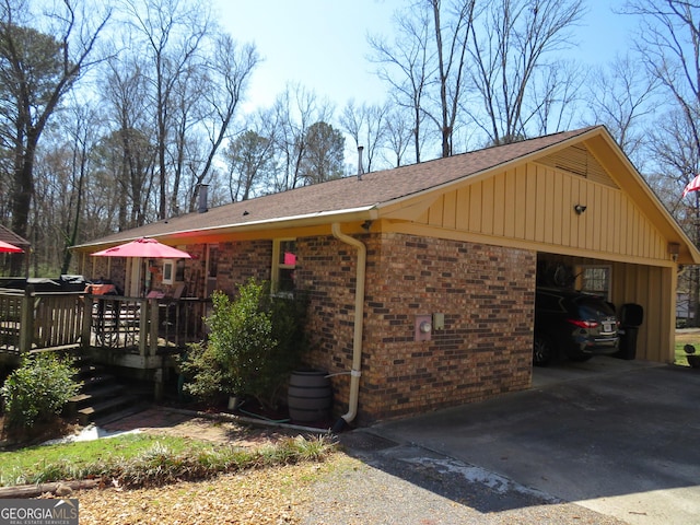 141 Cherokee Cir, Cedartown, GA 30125 - view of home's exterior with a garage, brick siding, a deck, and board and batten siding