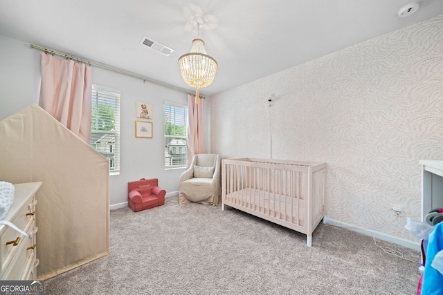 306 Coppergate Ct, Holly Springs, GA 30115 - carpeted bedroom featuring a chandelier and a crib