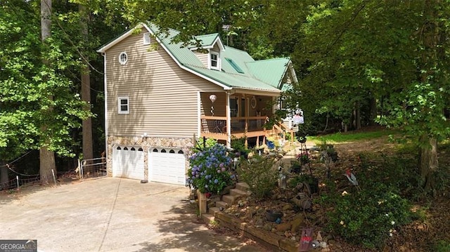 141 Mills Creek Path, Hiram, GA 30141 - view of property exterior featuring driveway, a garage, and stone siding