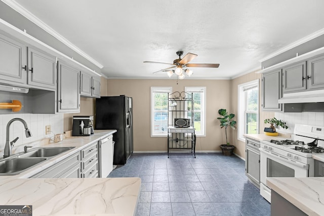 1072 Burtons Ferry Highway, Sylvania, GA 30467 - kitchen with white appliances, ceiling fan, under cabinet range hood, backsplash, and gray cabinetry
