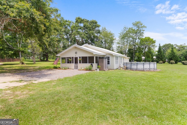 1072 Burtons Ferry Highway, Sylvania, GA 30467 - view of front facade with a sunroom, a covered pool, and a front lawn