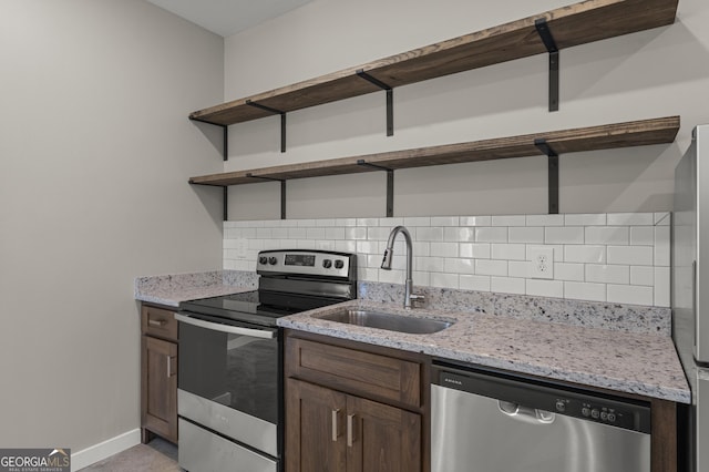 621 Arthur St, Lagrange, GA 30241 - kitchen featuring open shelves, stainless steel appliances, a sink, backsplash, and baseboards