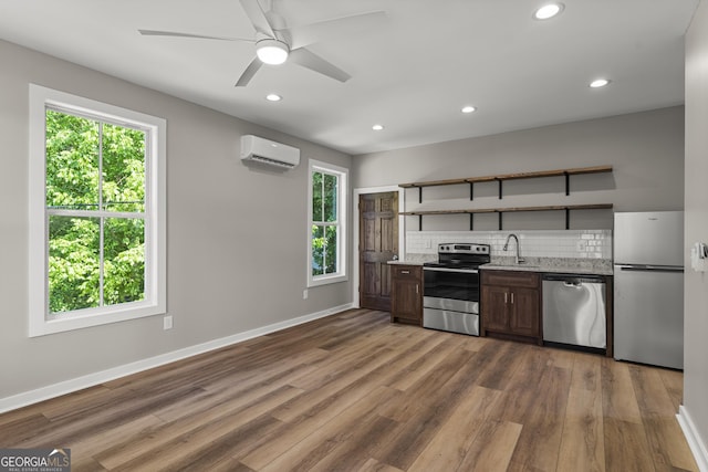 621 Arthur St, Lagrange, GA 30241 - kitchen with stainless steel appliances, a wall mounted air conditioner, open shelves, decorative backsplash, and a sink