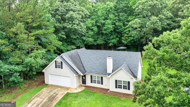 460 Old Tree Dr, Jackson, GA 30233 - view of front of property featuring concrete driveway, a chimney, a front lawn, and a garage