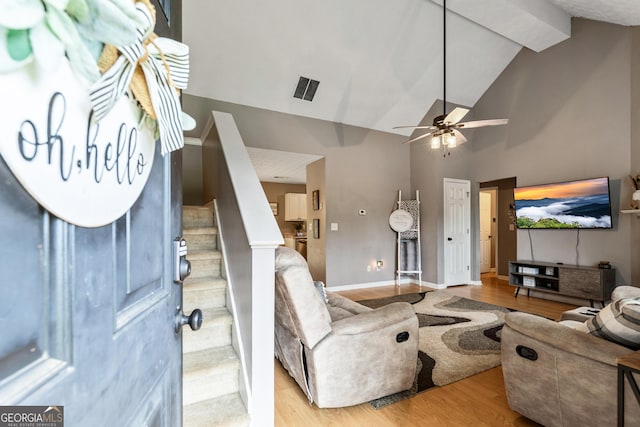 460 Old Tree Dr, Jackson, GA 30233 - living room featuring stairs, wood finished floors, ceiling fan, baseboards, and high vaulted ceiling