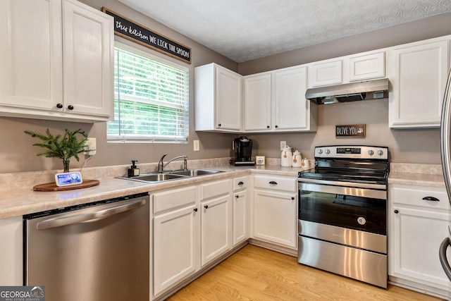 460 Old Tree Dr, Jackson, GA 30233 - kitchen featuring appliances with stainless steel finishes, under cabinet range hood, a sink, white cabinetry, and light countertops