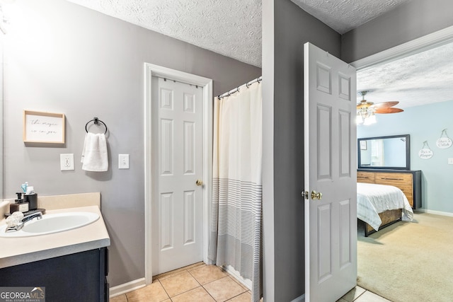 460 Old Tree Dr, Jackson, GA 30233 - full bathroom with a textured ceiling, vanity, tile patterned flooring, baseboards, and a ceiling fan
