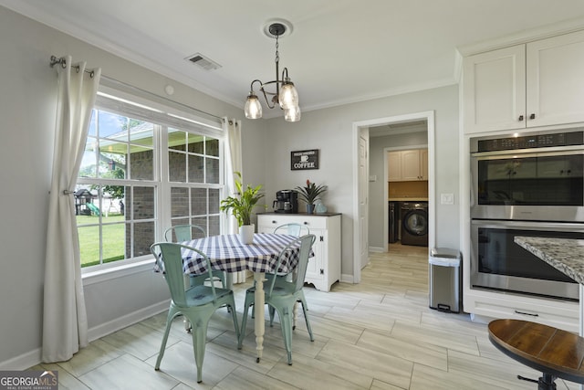 510 Braves Field Dr, Guyton, GA 31312 - dining room with washer / dryer, ornamental molding, healthy amount of natural light, a chandelier, and baseboards