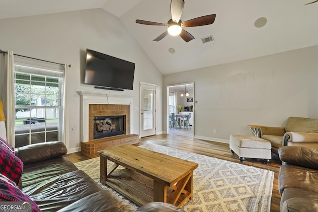 510 Braves Field Dr, Guyton, GA 31312 - living area featuring high vaulted ceiling, a ceiling fan, wood finished floors, a brick fireplace, and baseboards