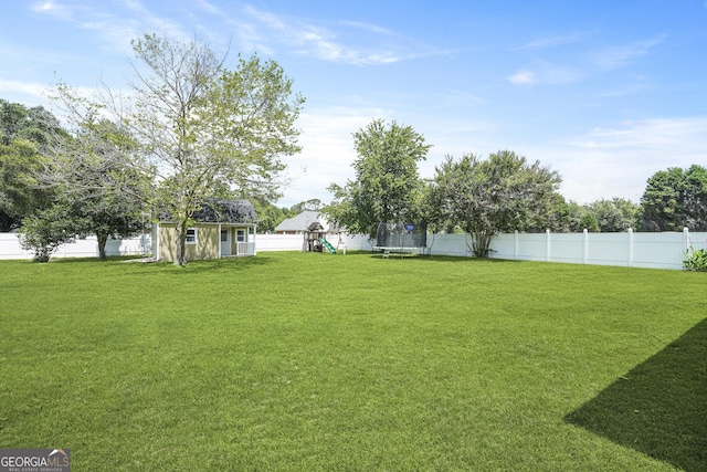510 Braves Field Dr, Guyton, GA 31312 - view of yard with a trampoline and a playground