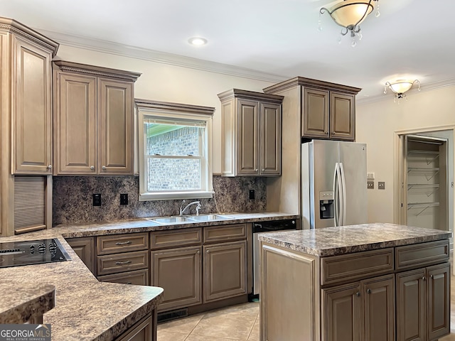 232 Darwish Dr, Mcdonough, GA 30252 - kitchen with appliances with stainless steel finishes, a sink, decorative backsplash, ornamental molding, and a kitchen island