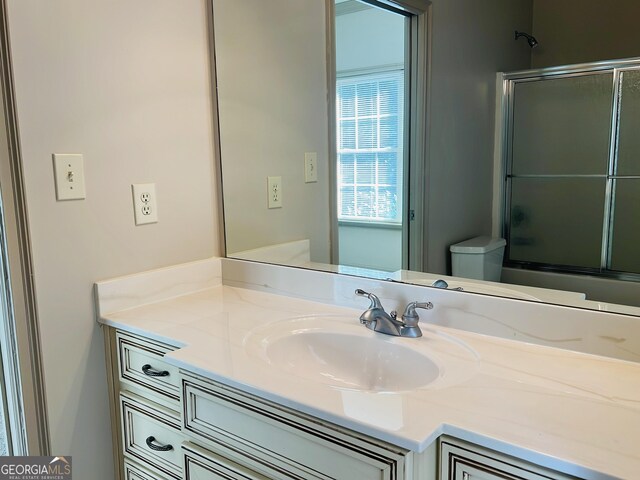 232 Darwish Dr, Mcdonough, GA 30252 - full bath featuring vanity, toilet, and combined bath / shower with glass door