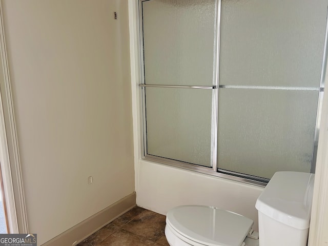 232 Darwish Dr, Mcdonough, GA 30252 - bathroom with toilet, enclosed tub / shower combo, and baseboards