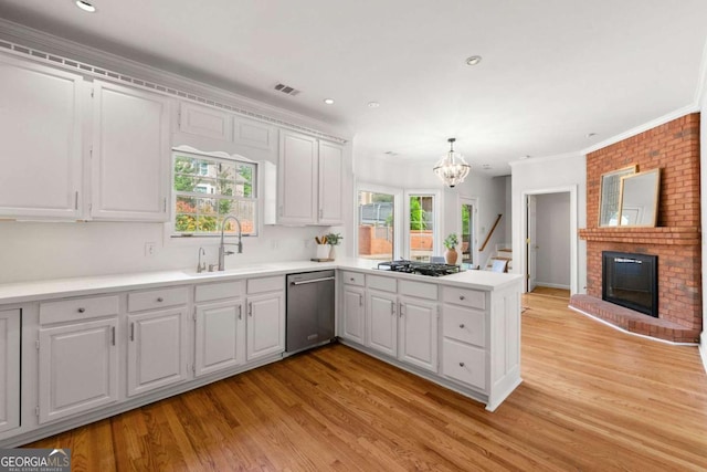 2903 Ashebrooke Dr NE, Marietta, GA 30068 - kitchen with stainless steel dishwasher, a peninsula, a sink, black gas cooktop, and plenty of natural light