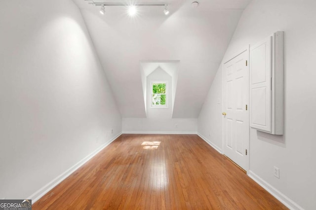 2903 Ashebrooke Dr NE, Marietta, GA 30068 - additional living space featuring vaulted ceiling, hardwood / wood-style floors, and baseboards