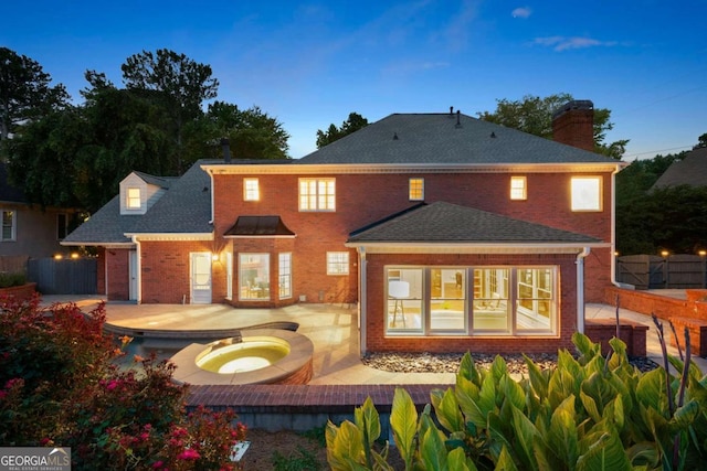 2903 Ashebrooke Dr NE, Marietta, GA 30068 - back of property with brick siding, a chimney, a patio area, an in-ground hot tub, and a shingled roof